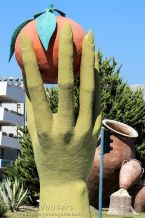 Statue of woman&#039;s hand holding an orange